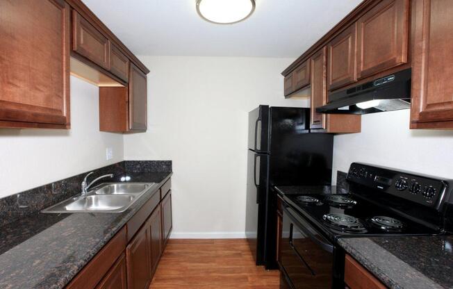 a modern kitchen with stainless steel appliances and wooden cabinets
