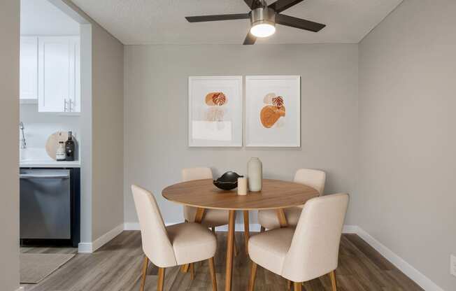 a dining room with a table and chairs and a ceiling fan