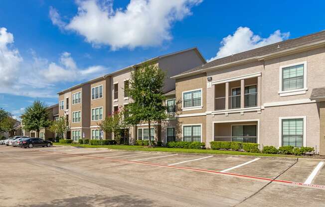 an empty parking lot in front of an apartment building at Summerwind, Pearland, TX
