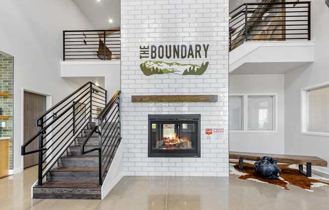 A modern living room with a fireplace and a staircase.