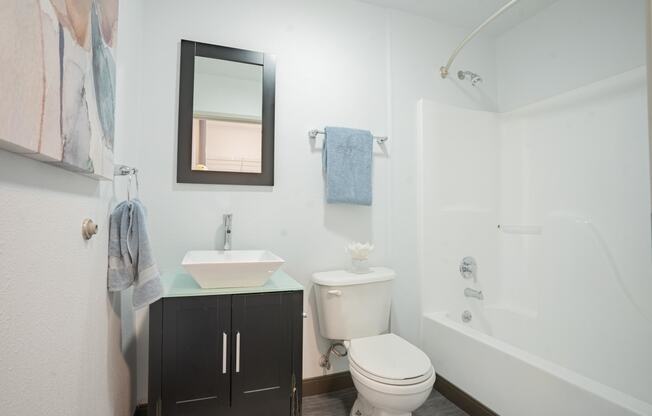 a bathroom with a toilet sink and a shower