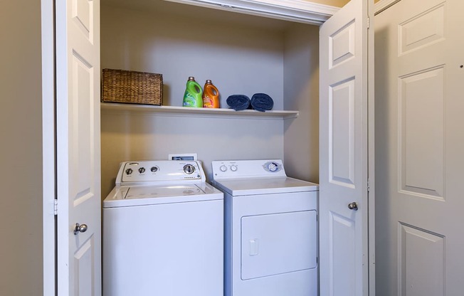 A small laundry room with a washer and dryer.