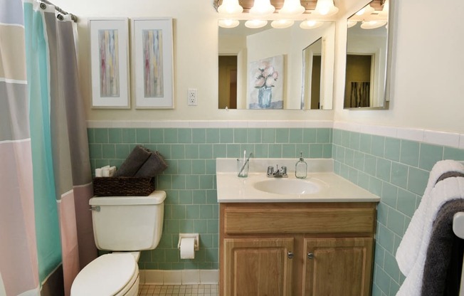 Bathroom with a toilet sink and mirror at Hyde Park Apartments*, Essex