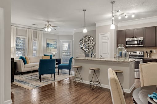 A kitchen with a dining table and chairs.
