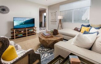 Living area with large windows and TV