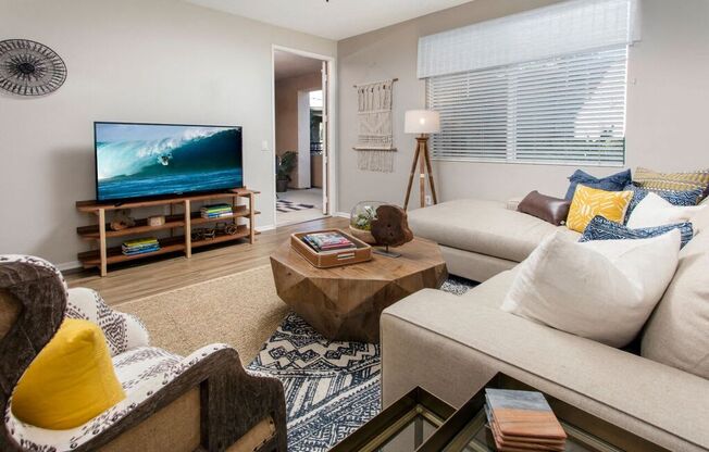 Living area with large windows and TV