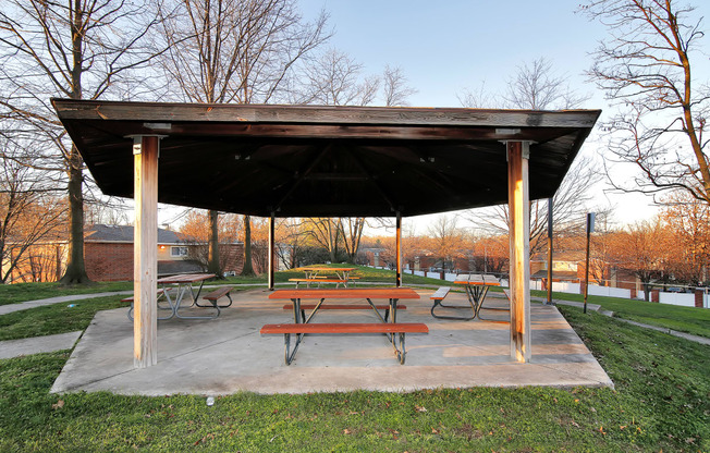 a picnic table under a shelter in a park