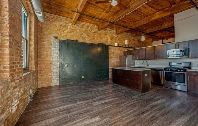 Spacious living area with a huge kitchen island at Carriage House Lofts, Illinois