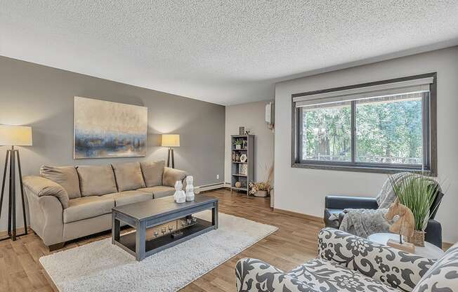 a living room with a couch and two chairs