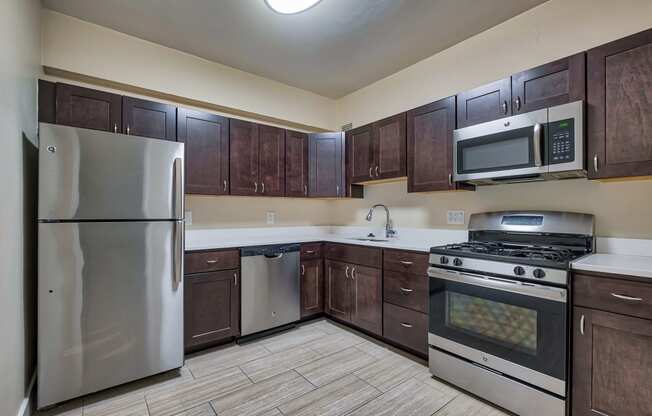 a kitchen with stainless steel appliances and wooden cabinets