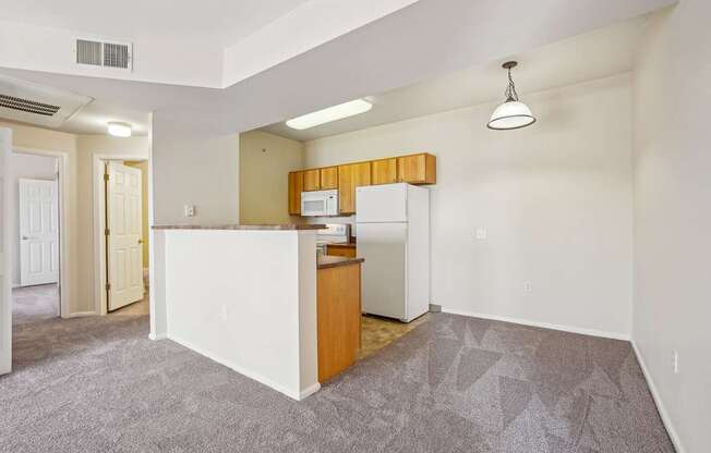 A kitchen area with a white counter and a microwave.