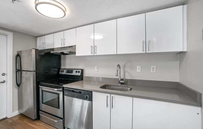 Open Kitchen Island quartz white cabinets natural light spacious RISD Brown University Rhode Island State House  Downtown Providence Plank flooring dishwasher stainless steel appliances laundry  Tstop MBTA walkable