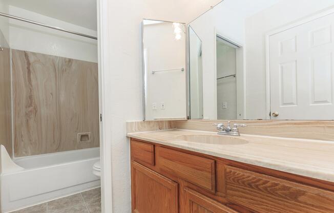 a white tub sitting next to a sink