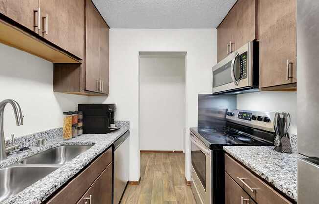 A kitchen with brown cabinets and a white door.
