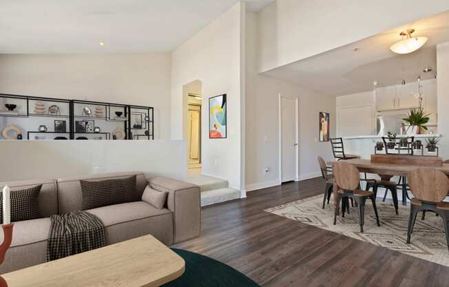 a living room and dining room with a table and a couch