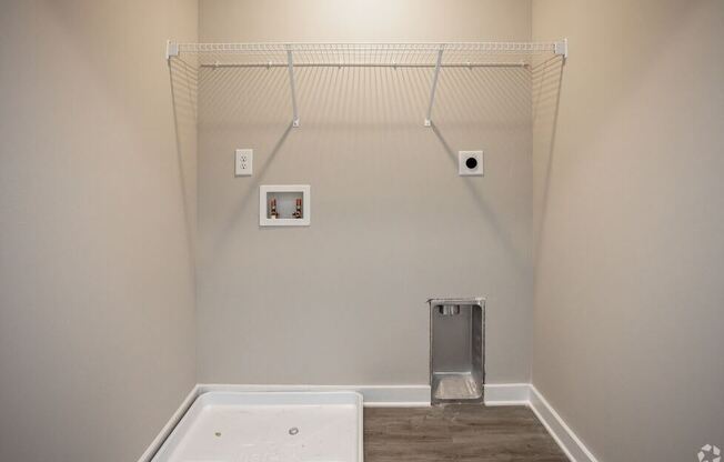 a bathroom with a white tub and a wall with a shower