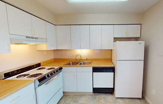 a kitchen with white appliances and white cabinets