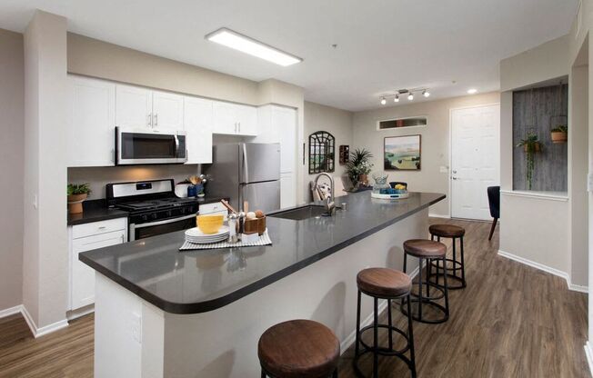 Kitchen with stainless steel appliances and bar seating