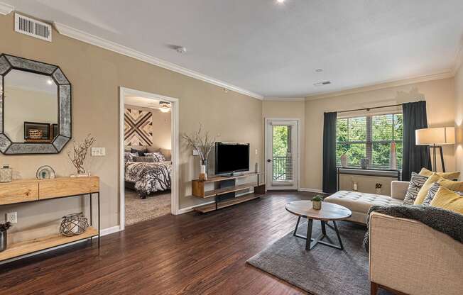 a living room with hardwood floors and beige walls