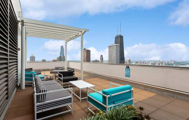 a roof top lounge with a view of the chicago skyline