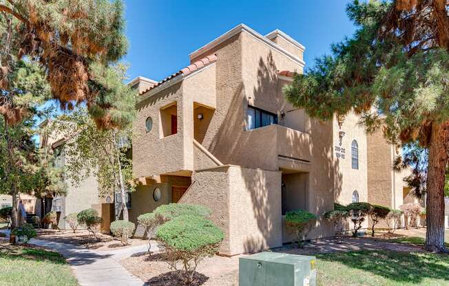 a building with a staircase and trees in front of it at Pacific Harbors Sunrise Apartments, Nevada