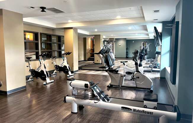a spacious fitness center with treadmills and ellipticals