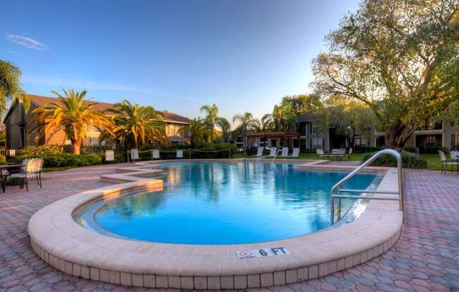 This is one of our three pools, with beautiful paver deck surrounded by lush landscaping.