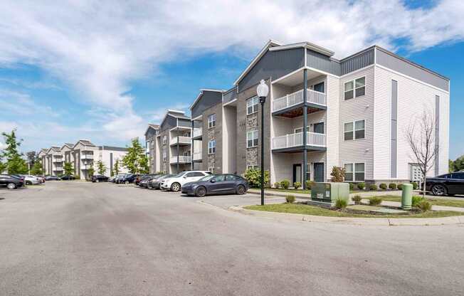 A parking lot in front of apartment buildings.