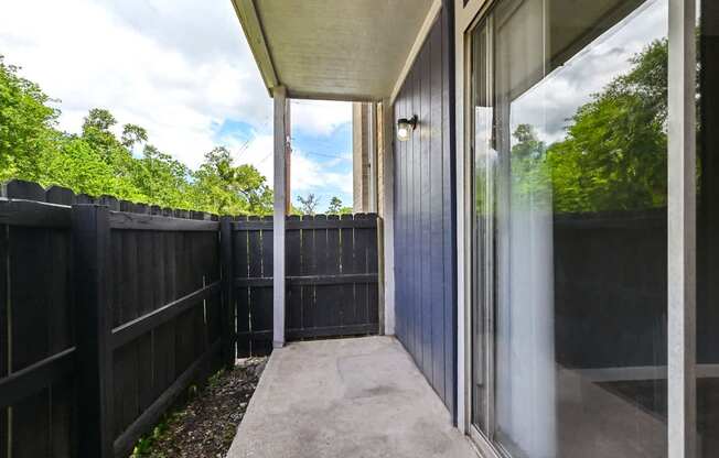 A view of a patio with a sliding glass door.