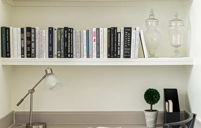a home office with a desk and bookshelves