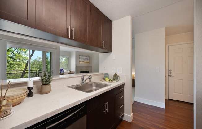 an empty kitchen with a sink and a window