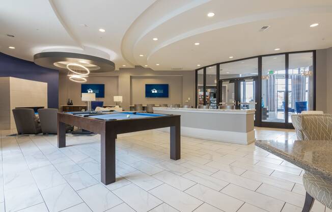 a game room with a pool table and a bar