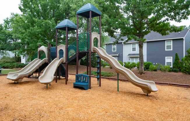 A playground with a brown slide and a green and blue structure.