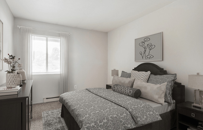 A bedroom with a large bed and a painting on the wall.