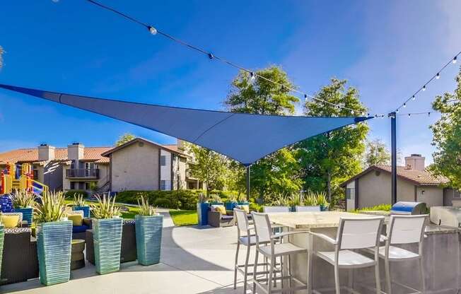 Temecula, CA Apartments - Exterior View of Vista Promenade Apartments Building Surrounded By Lush Landscaping with View of Outdoor Lounge