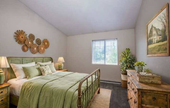 a bedroom with a bed and a painting on the wall