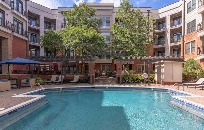 A swimming pool in front of apartment buildings.