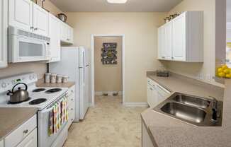 Kitchen With White Cabinetry And Appliances at Abberly Place at White Oak Crossing Apartments, HHHunt Corporation, North Carolina