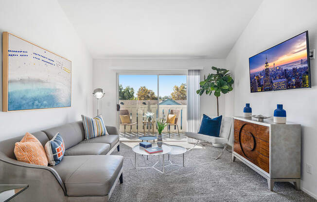 a living room with a couch and a coffee table and a large window