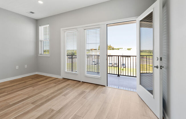 A room with a sliding glass door leading to a balcony at Madison Prickett Preserve, Yardley, PA
