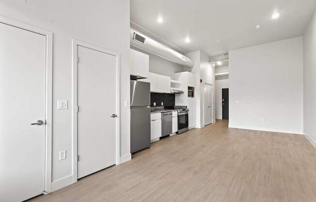 A kitchen with white appliances and cabinets is shown. at Brickside Heights, Millcreek, Utah