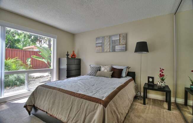 Bedroom with Floor to Ceiling Windows at Casa Alberta Apartments, California