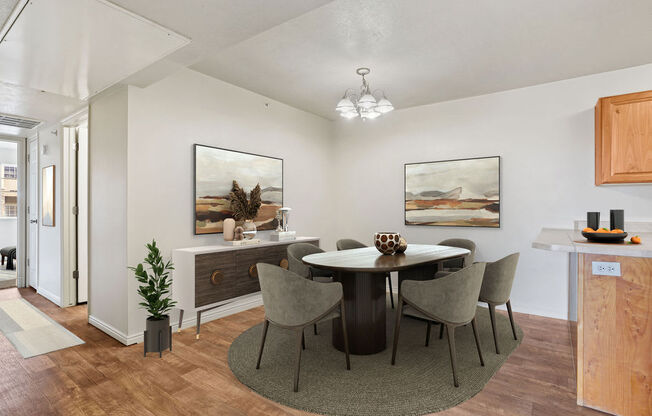 a dining room with a round table and chairs