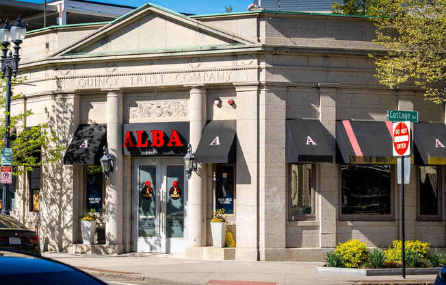 A building with a red sign that says Alba.
