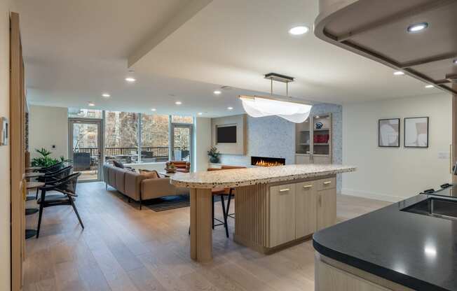 a kitchen with a bar and a living room with a fireplace