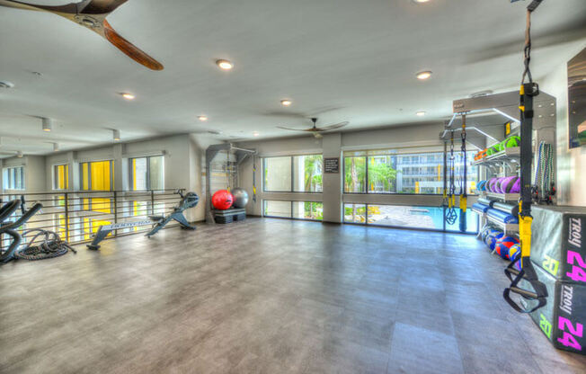 a workout room with a treadmill and weights at the preserve at great pond apartments in windsor  at Fusion, Florida