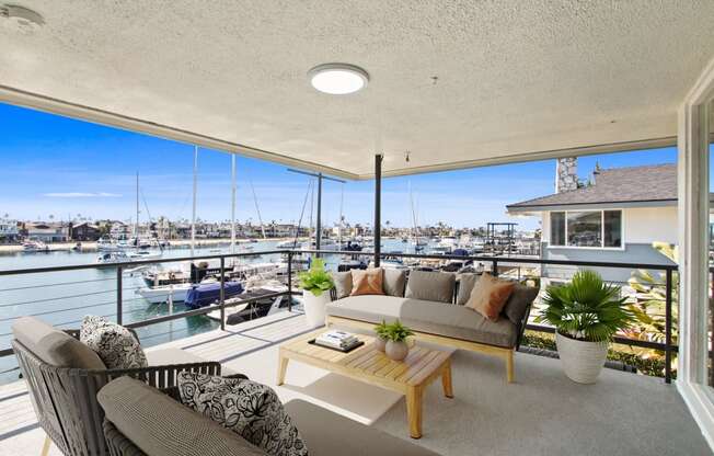 a living room with a balcony overlooking a marina