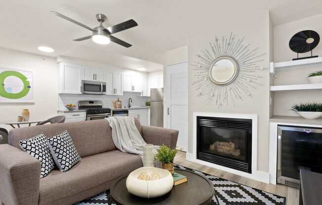 a living room with a couch and a coffee table in front of a fireplace