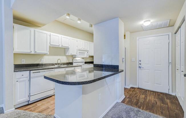 a kitchen with white cabinets and a counter top