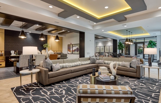 a large living room with couches and tables at Aura Stonebridge, Virginia, 23225